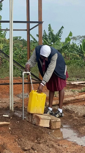 Anna collecting clean water from the school water point