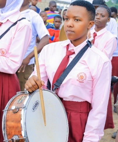 Lilian Sifa holding a drum during a Brass Band Club performance